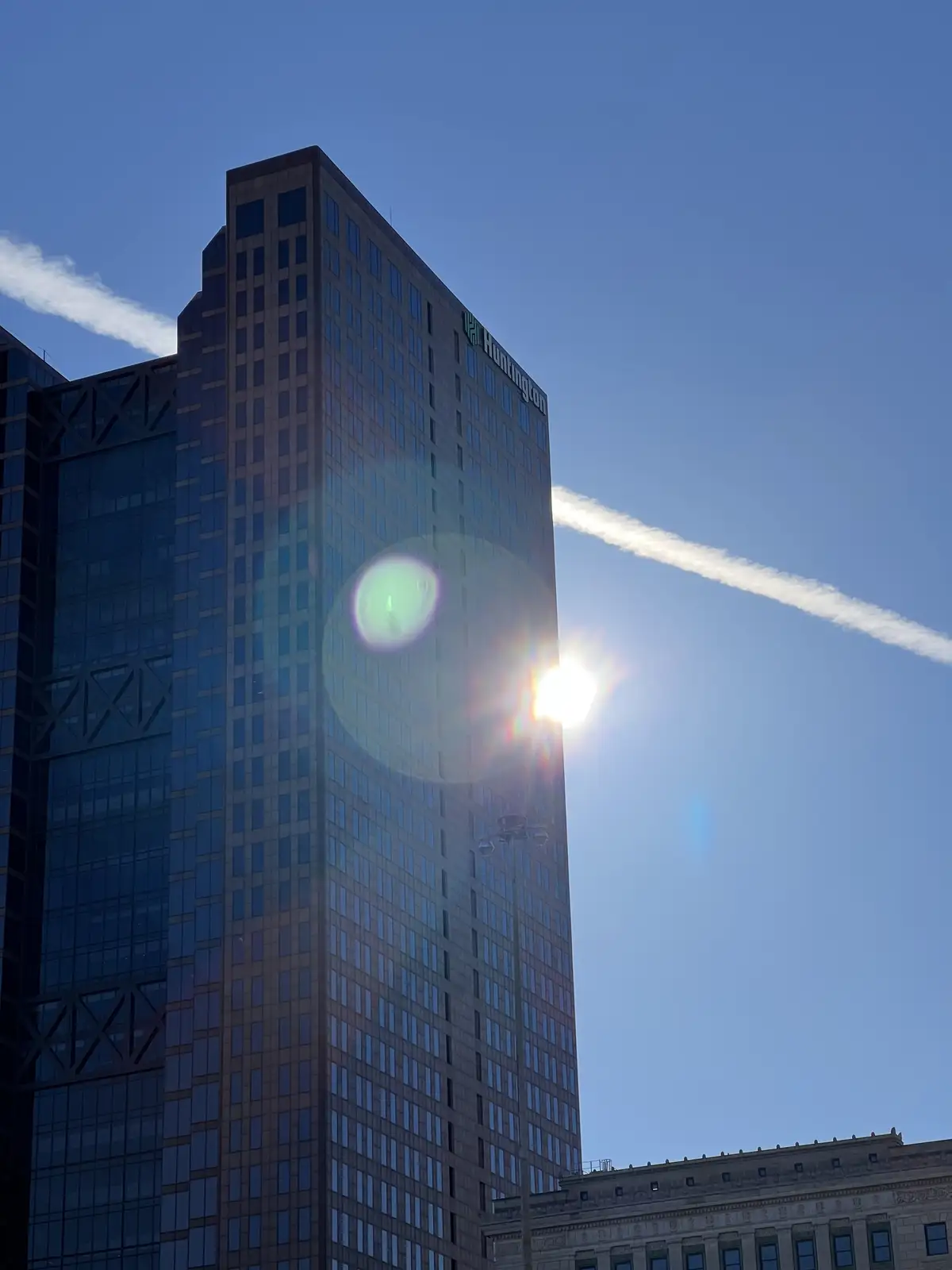 City tower catches a dazzling sunburst. Still Frame