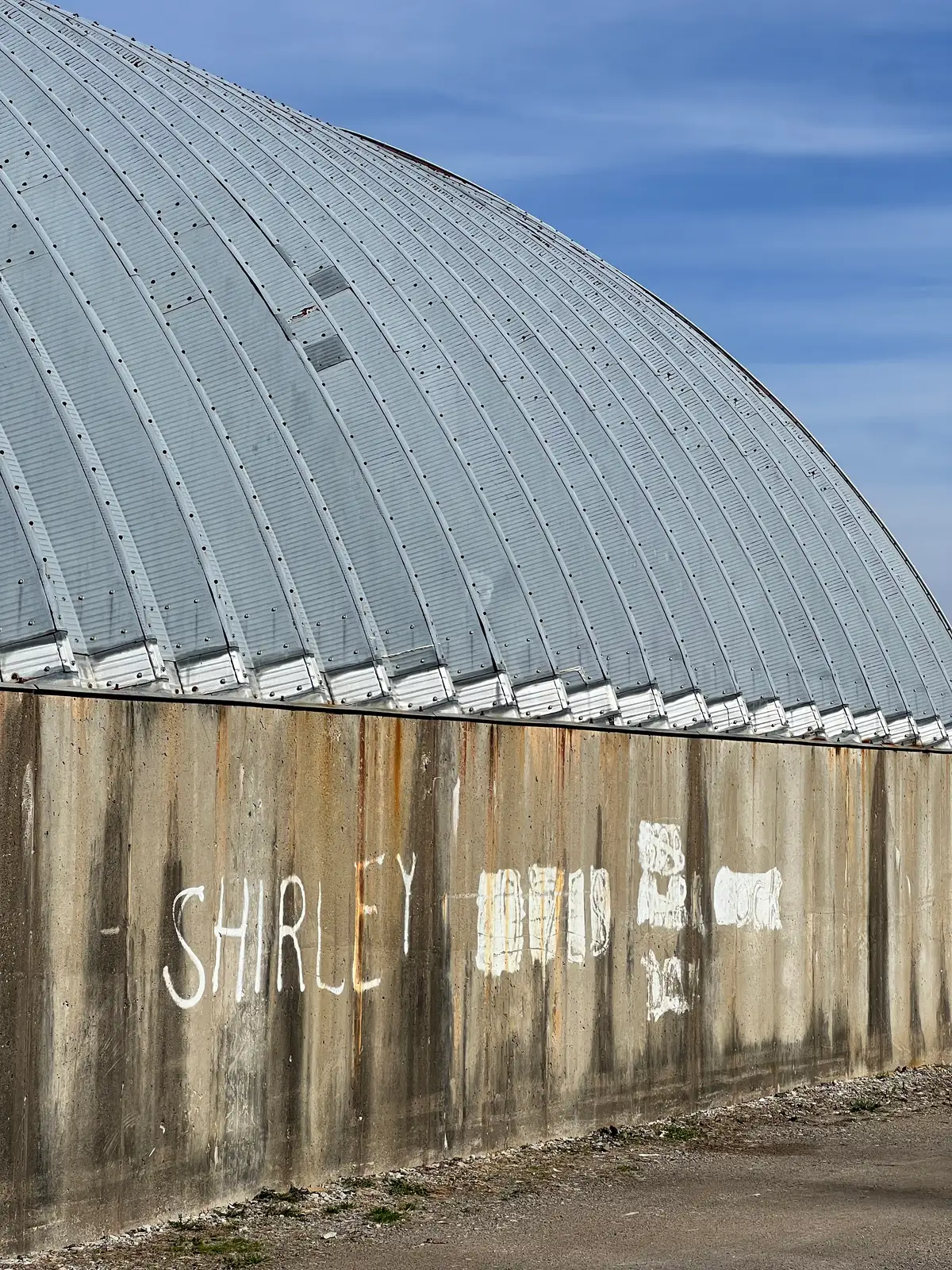 Steel curves, concrete secrets, and a whispered name. Still Frame