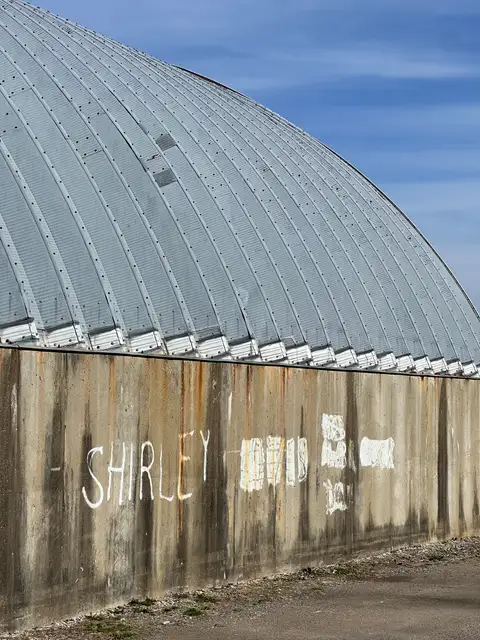 Steel curves, concrete secrets, and a whispered name.