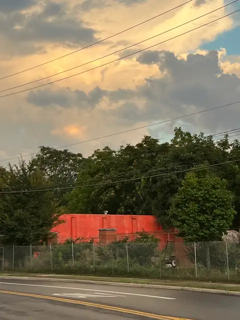Vibrant orange-red building and a dramatic sky in Grandview Heights, Ohio | Licensable photo asset by Dylan Stanley