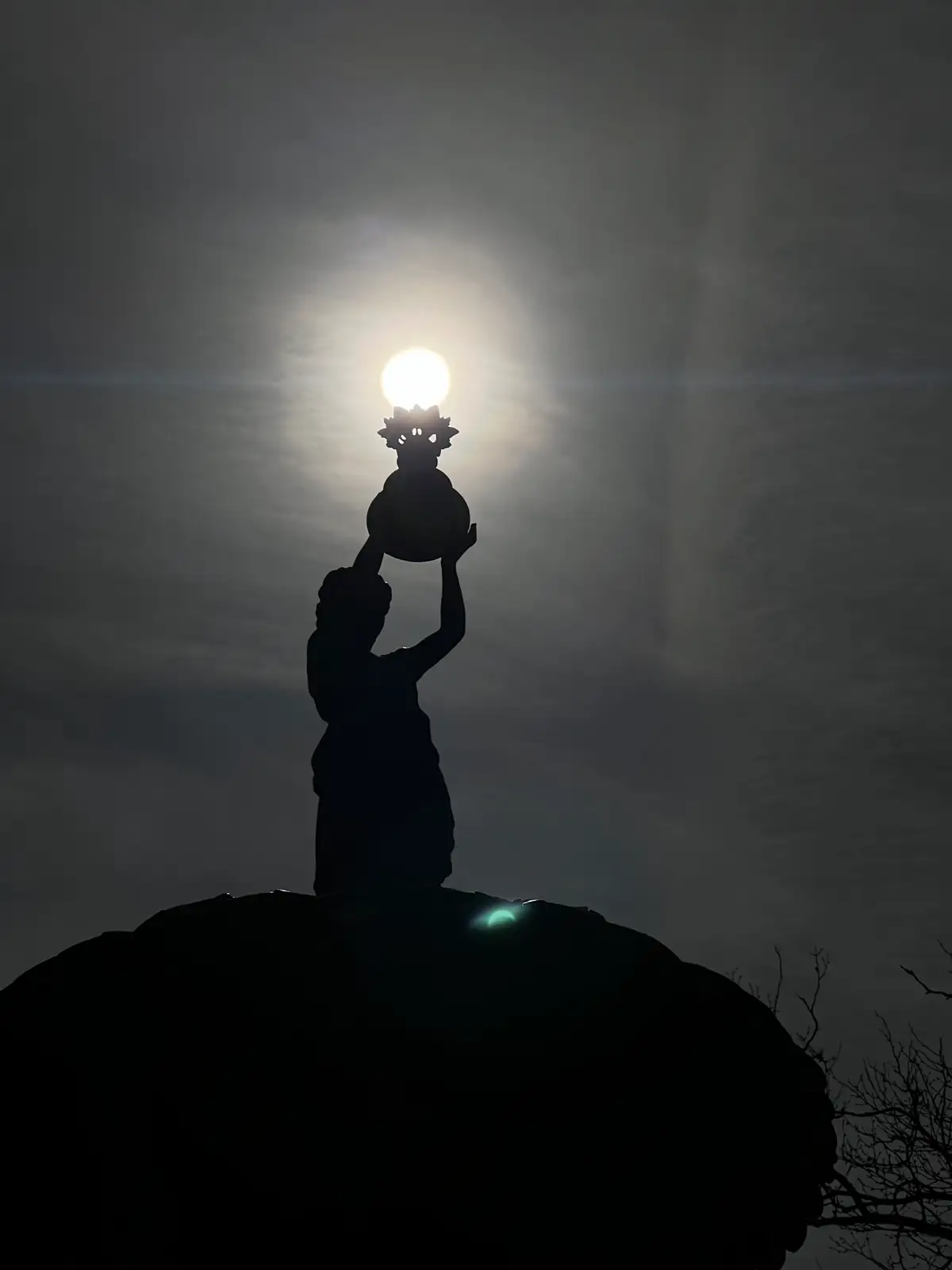 Holding the sun in her hands, a divine glow in the fading light. Still Frame