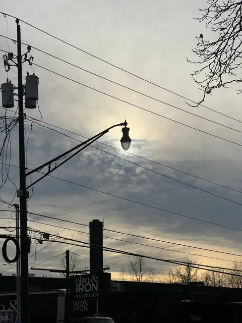 Urban glow, finding light amidst the dramatic clouds.
