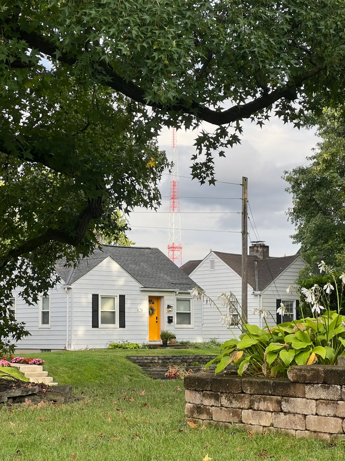 Steel giants looming over shingled roofs. Still Frame