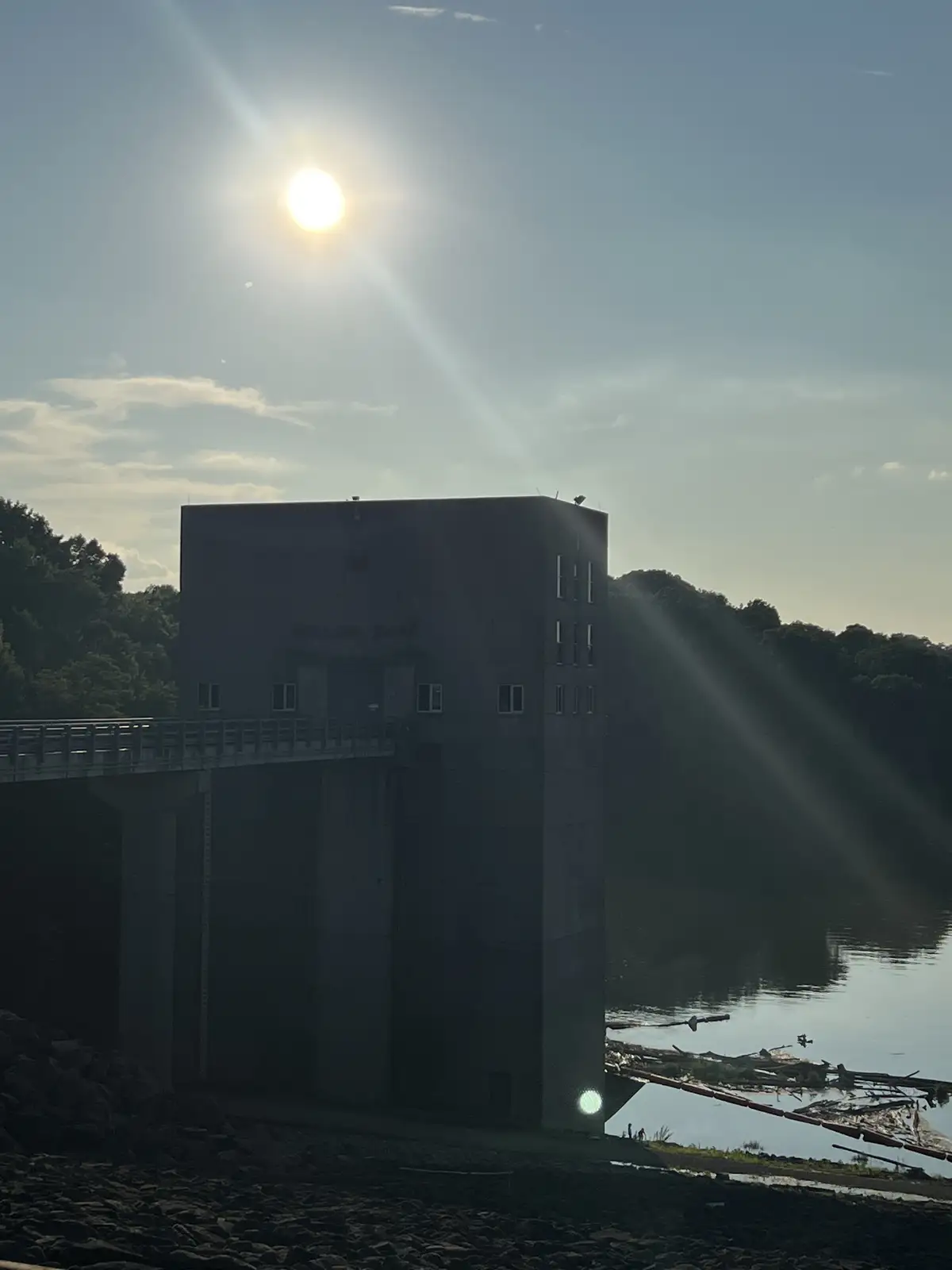 Sun-drenched concrete meets serene waters and green hills. Still Frame