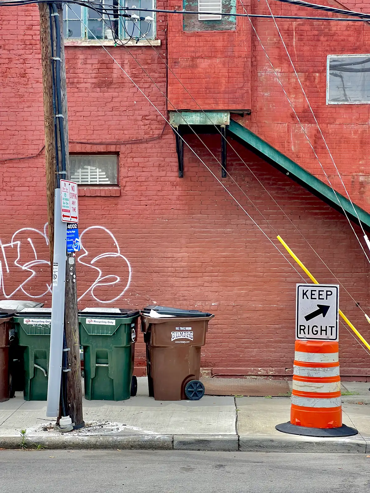 Urban layers: brick, wires, and street signs.