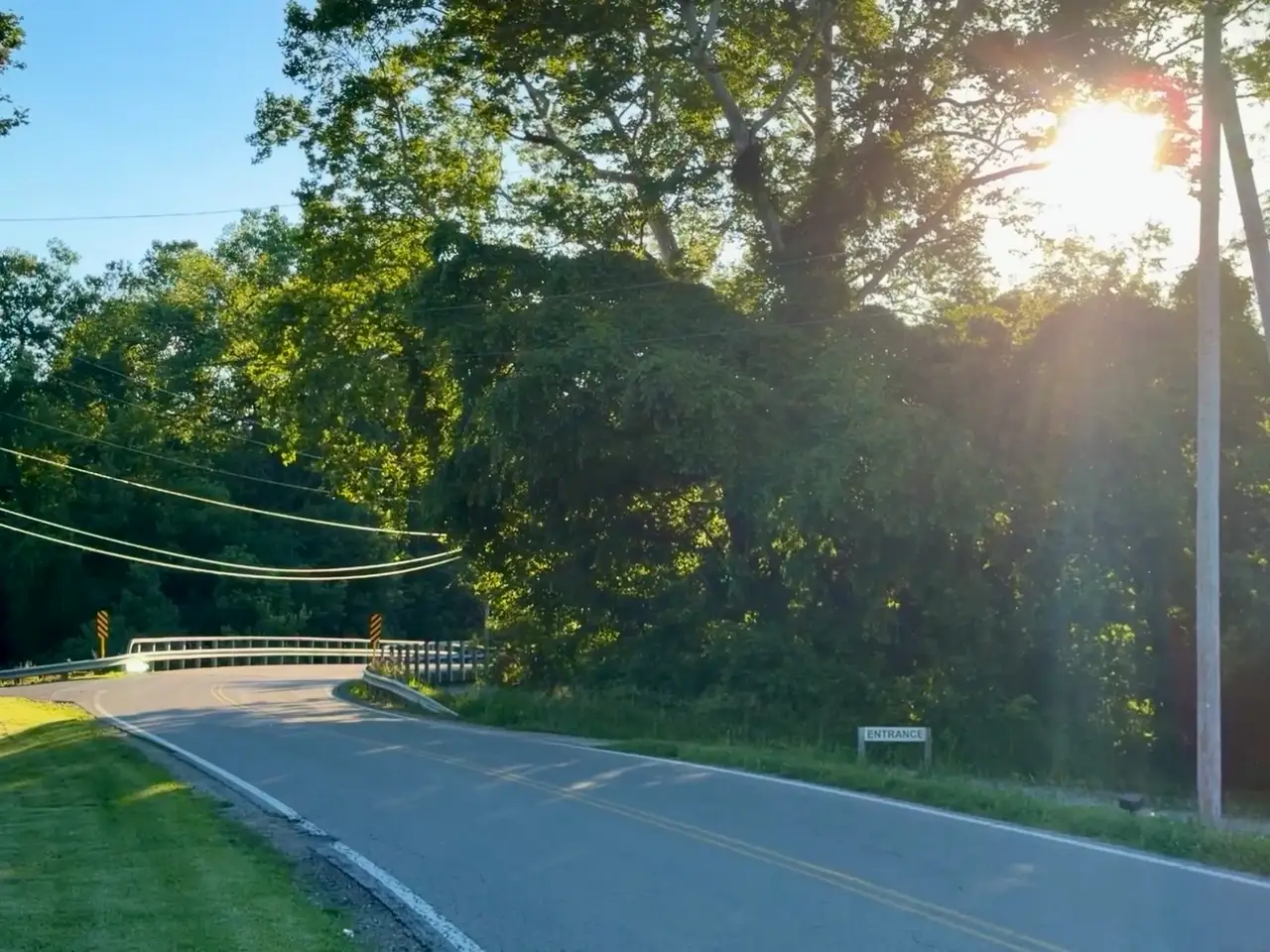 Summer days and sun flares on the winding road ahead. Still Frame