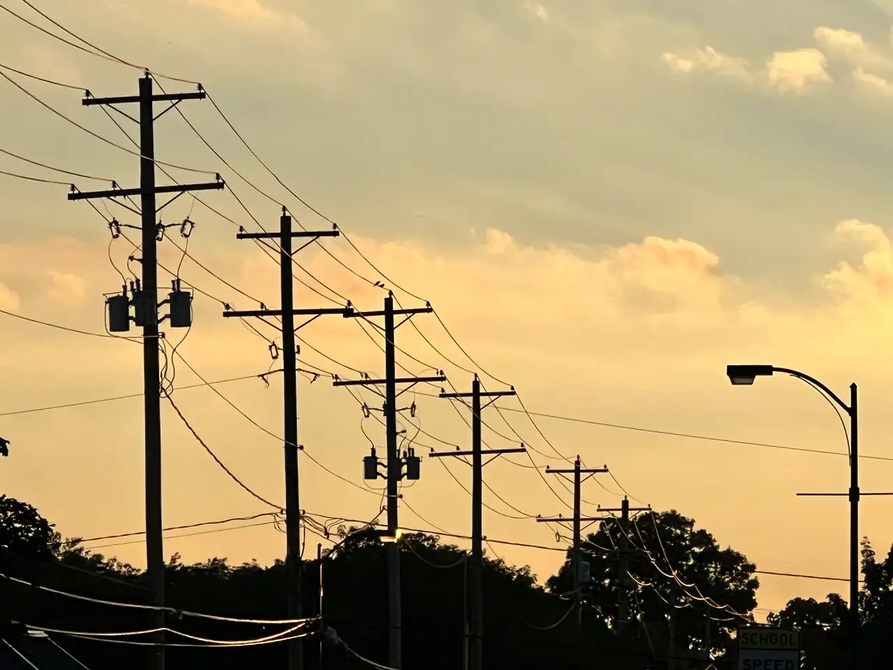 Urban veins catch the last light of a golden sky.