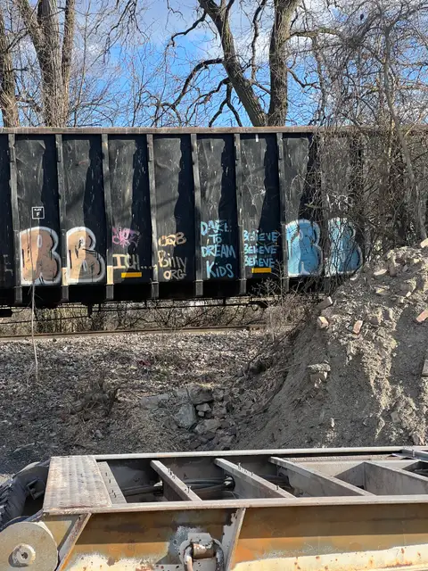 Gritty urban art on a passing train.