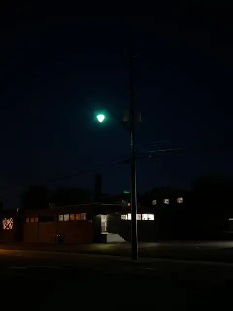 Green light glows in the quiet urban night.