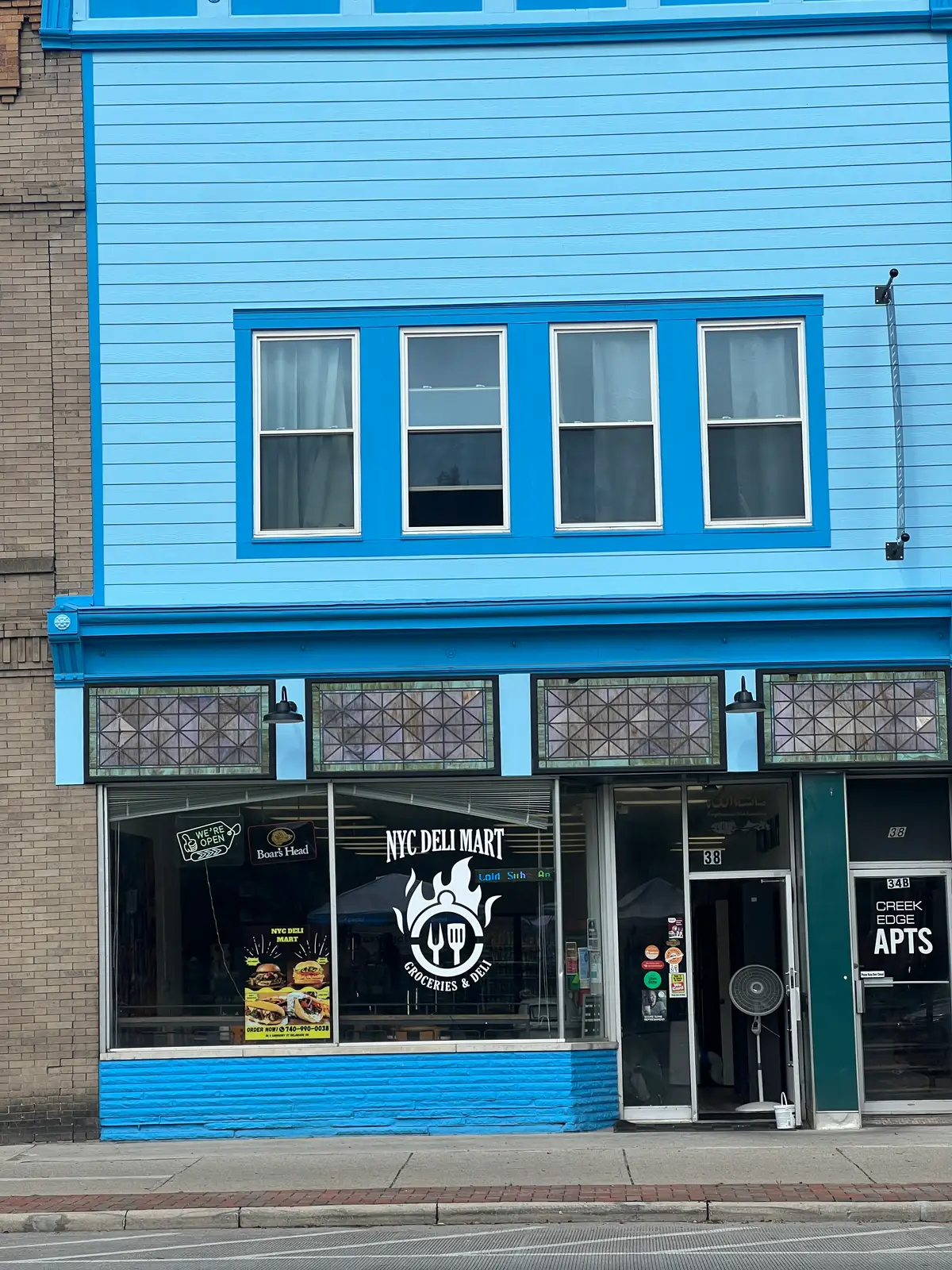 That electric blue facade really grabs your eye! Still Frame