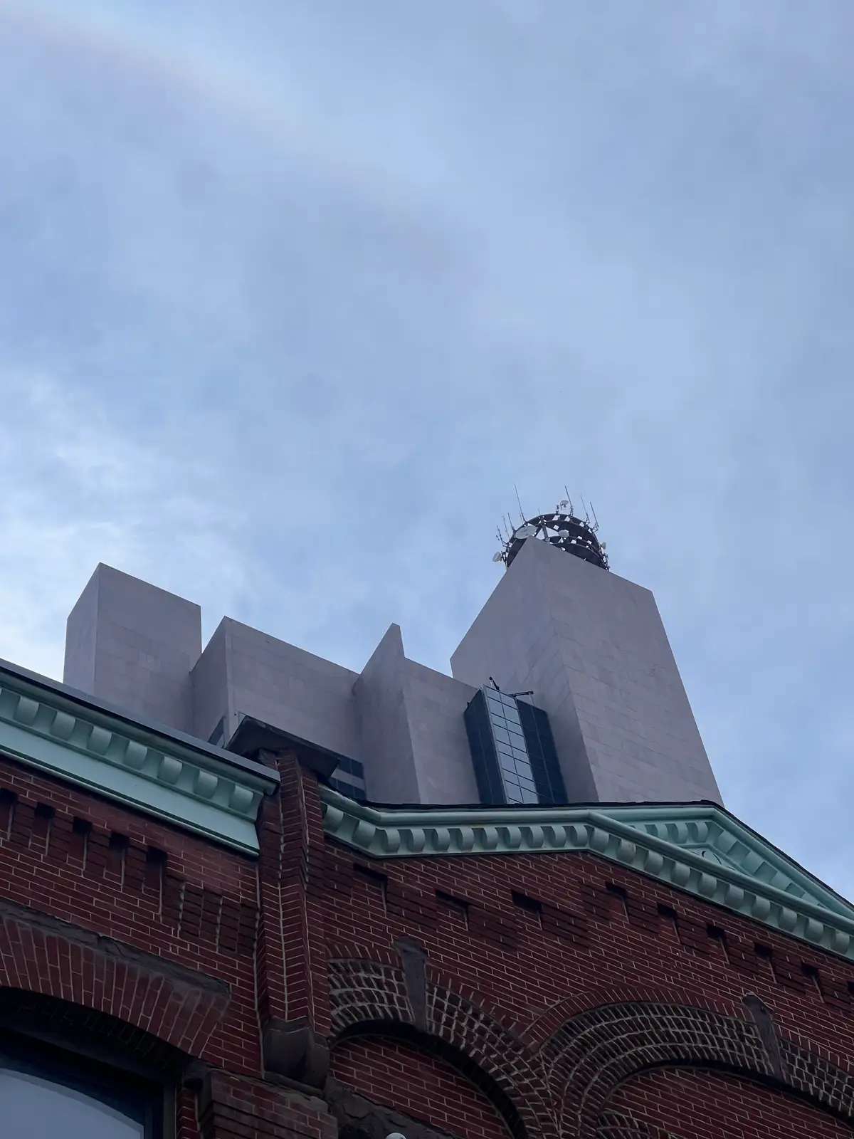 Skyward gaze at historic brick and modern lines. Still Frame