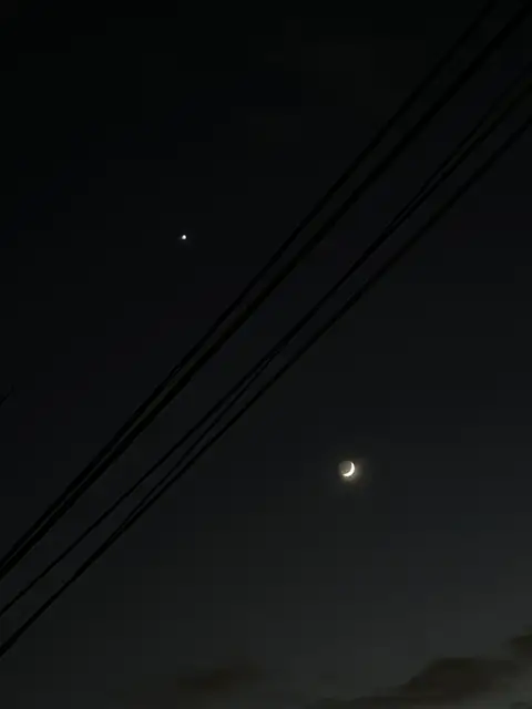 Celestial beauty meets urban lines.