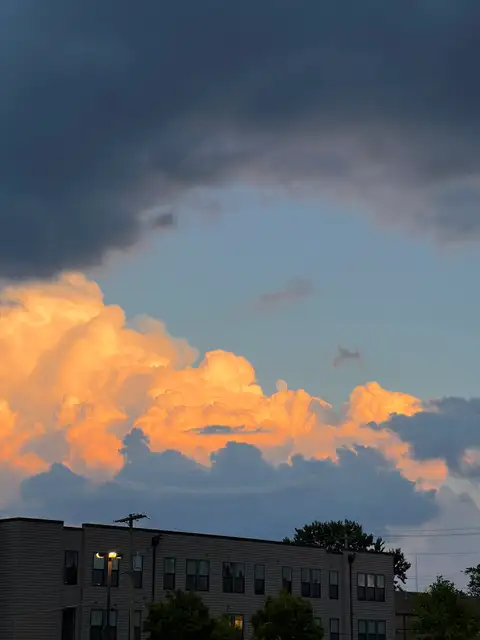 Golden clouds meet stormy skies.