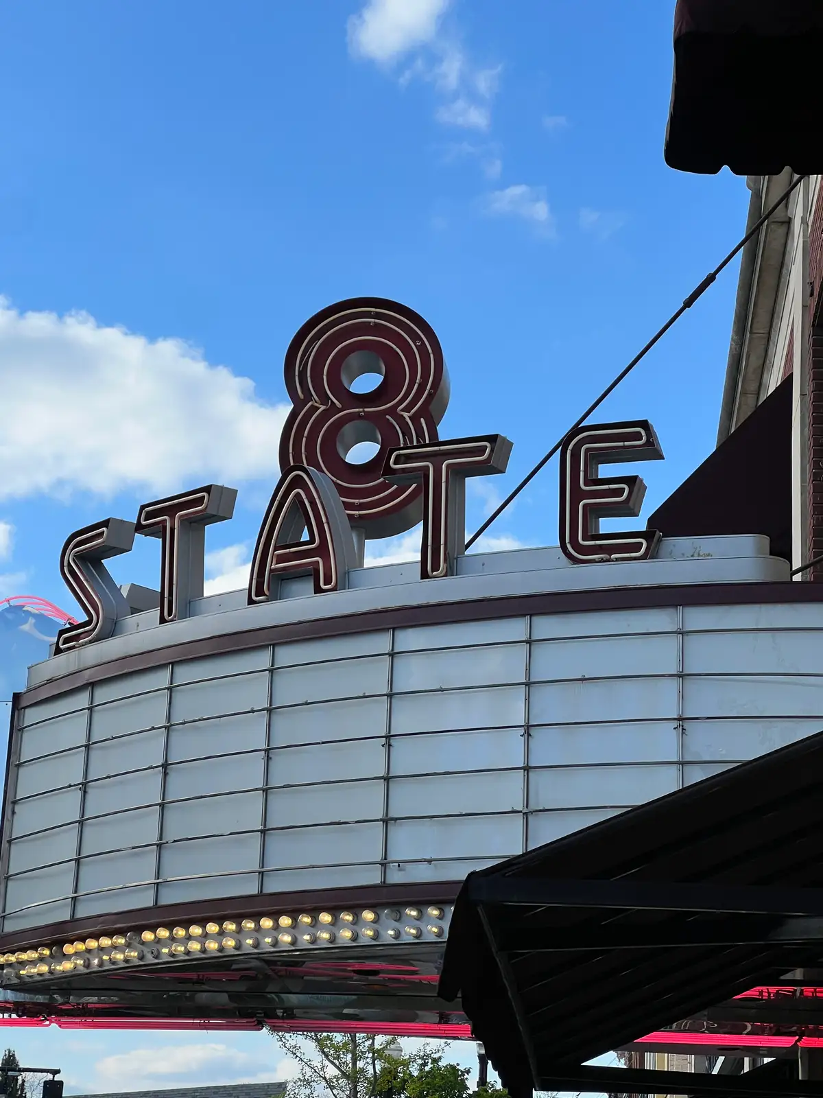 Timeless State 8 marquee lights up the clear blue. Still Frame