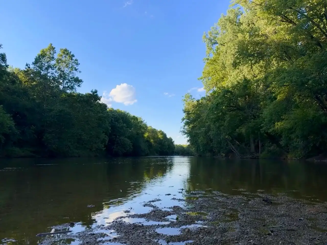 Serene waters reflect a perfect summer sky. Still Frame