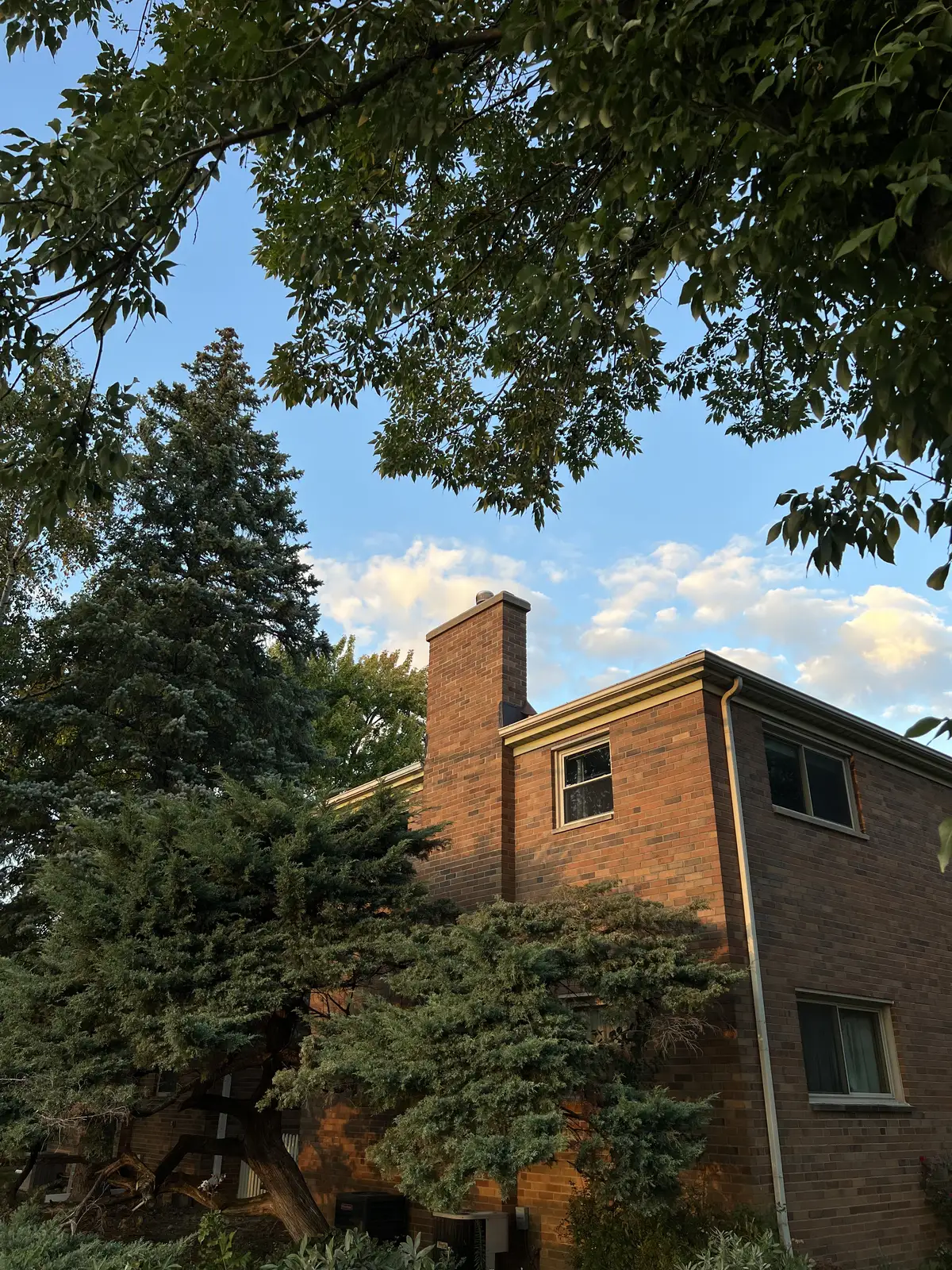 Golden hour glow on a cozy brick home. Still Frame